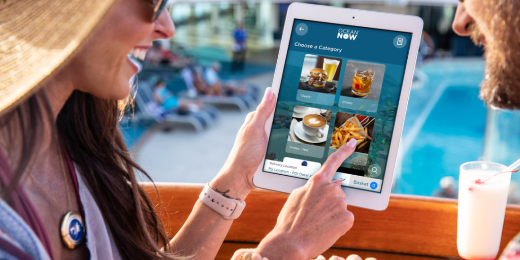 Couple ordering food on a tablet with Princess Cruises OceanNow