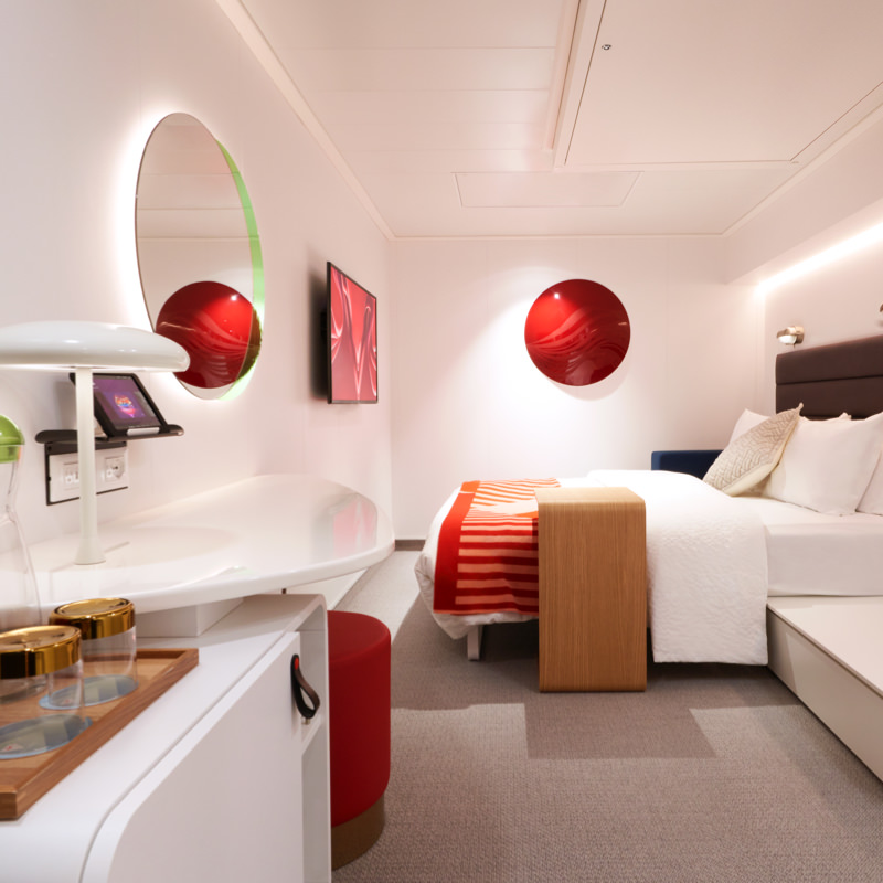 Modern cruise ship cabin interior at night with mood lighting