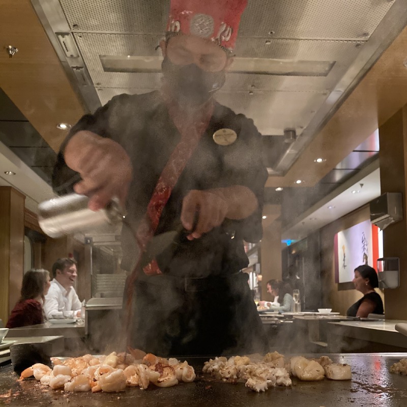 Chef at the Teppanyaki restaurant pouring soy sauce