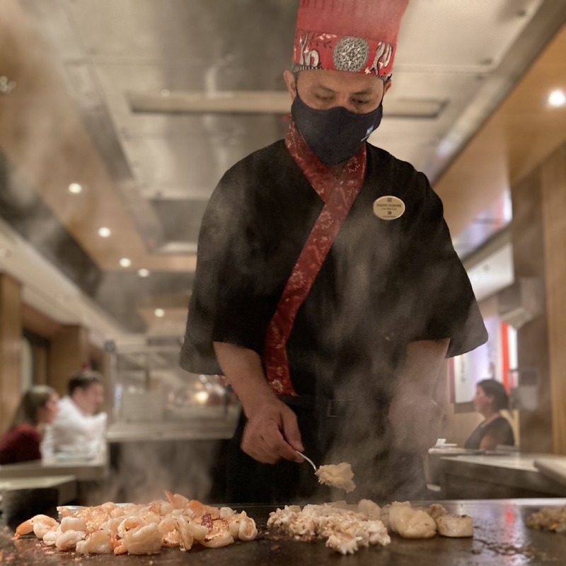 Chef at the Teppanyaki restaurant grilling prawns
