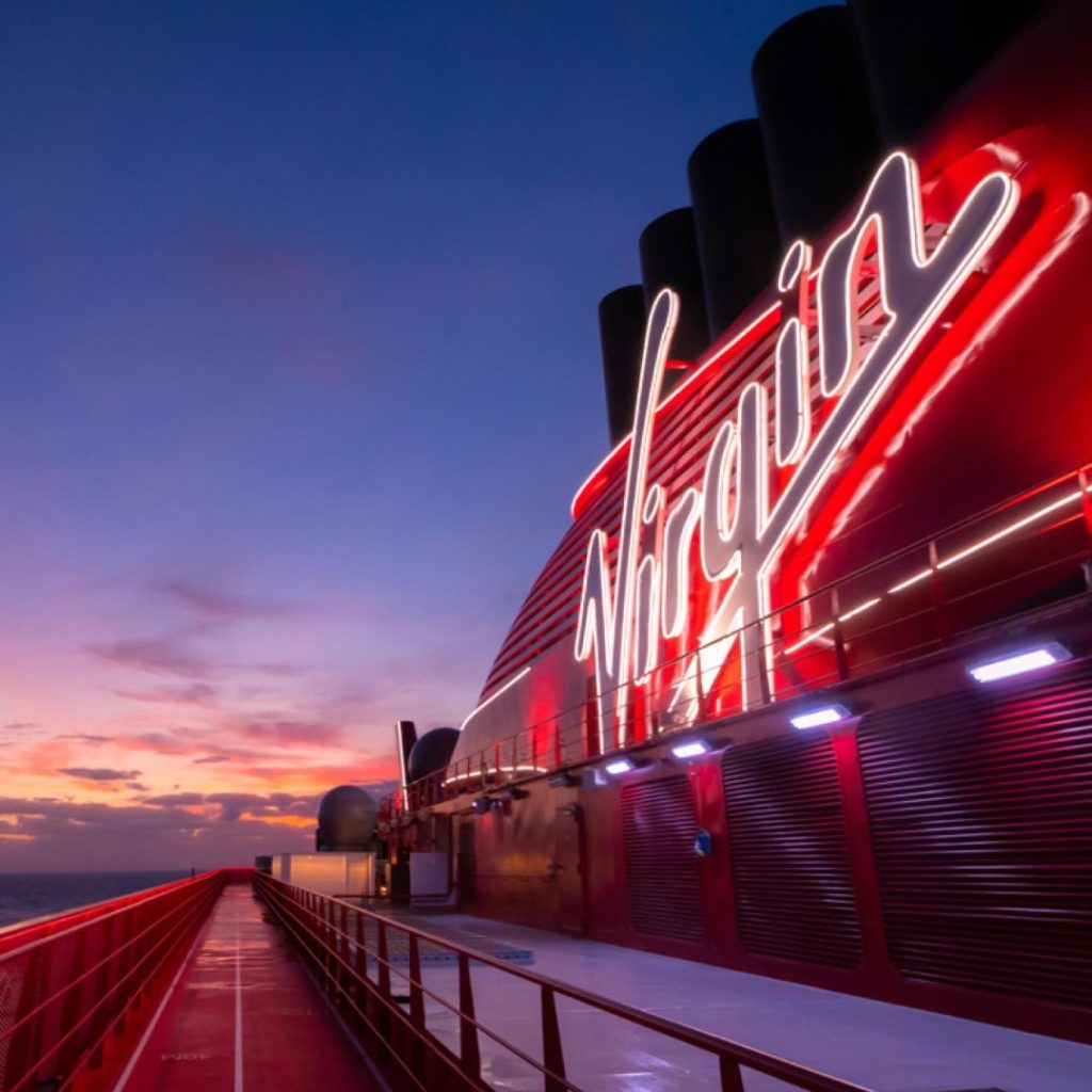 Virgin Voyages' Scarlet Lady funnel at sunset