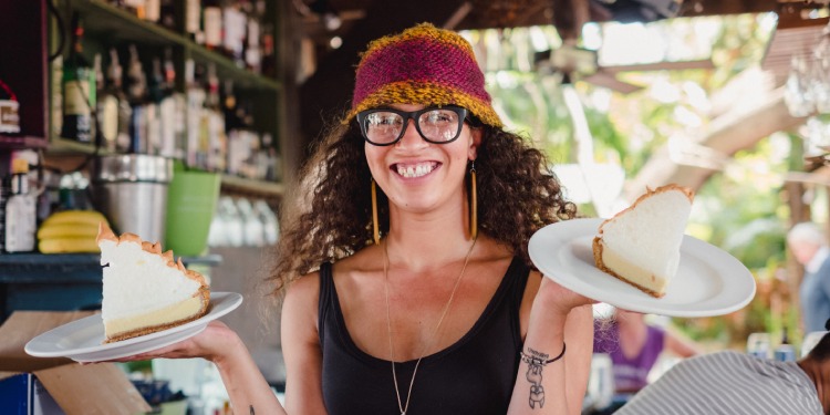 Server showing off two huge key lime pies