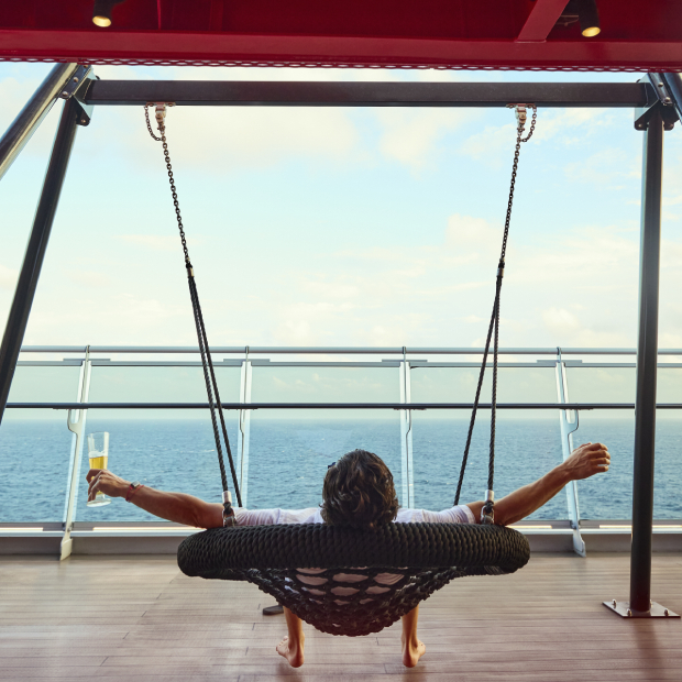 Virgin Voyages Sailing Club guests on the swing