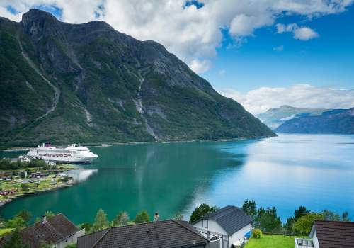 Ambassador Cruise Line ship docked in a fjord in Norway