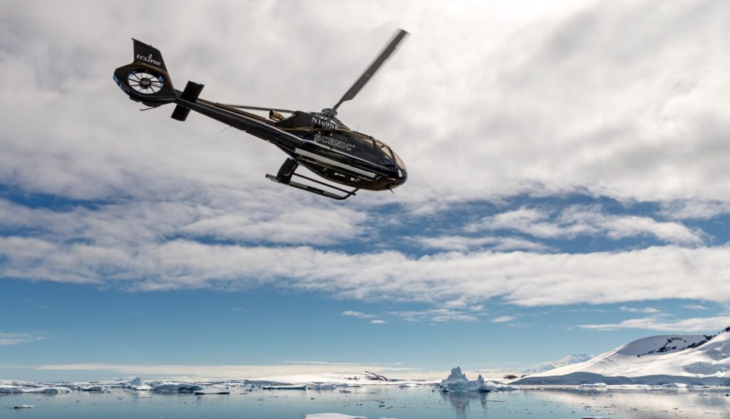 Airbus H130-T2 in flight over ice, coast or mountains