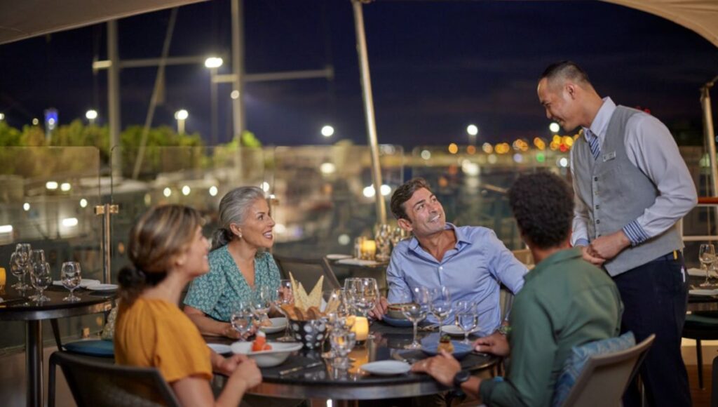 Windstar crew member serving guest onboard Star Breeze
