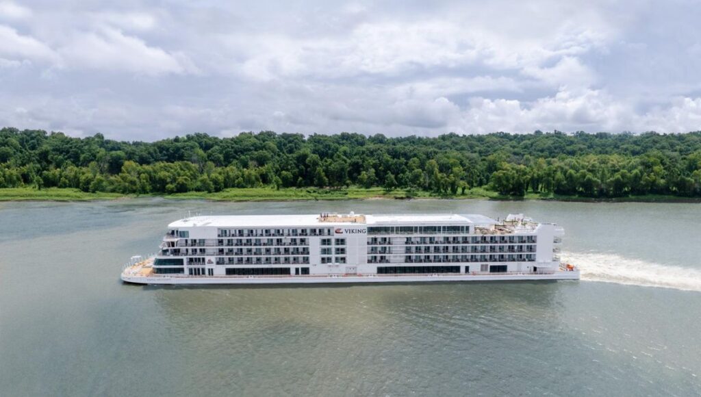 Modern luxury river cruise ship sailing through tropical rainforest river landscape