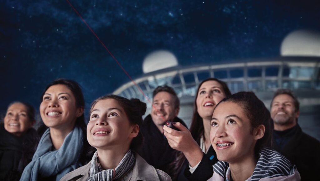 Family watching the stars from the deck during a Caribbean cruise