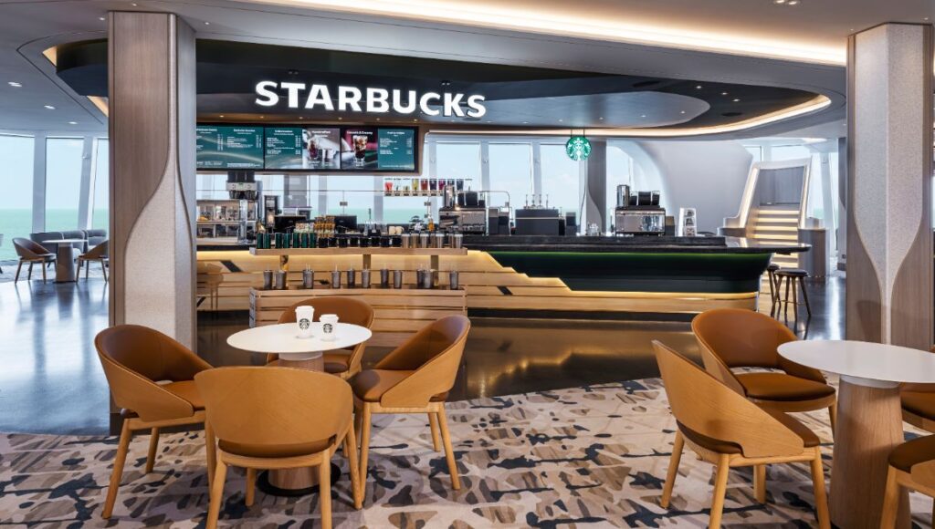 Starbucks café on Norwegian Luna with ocean views and modern seating area