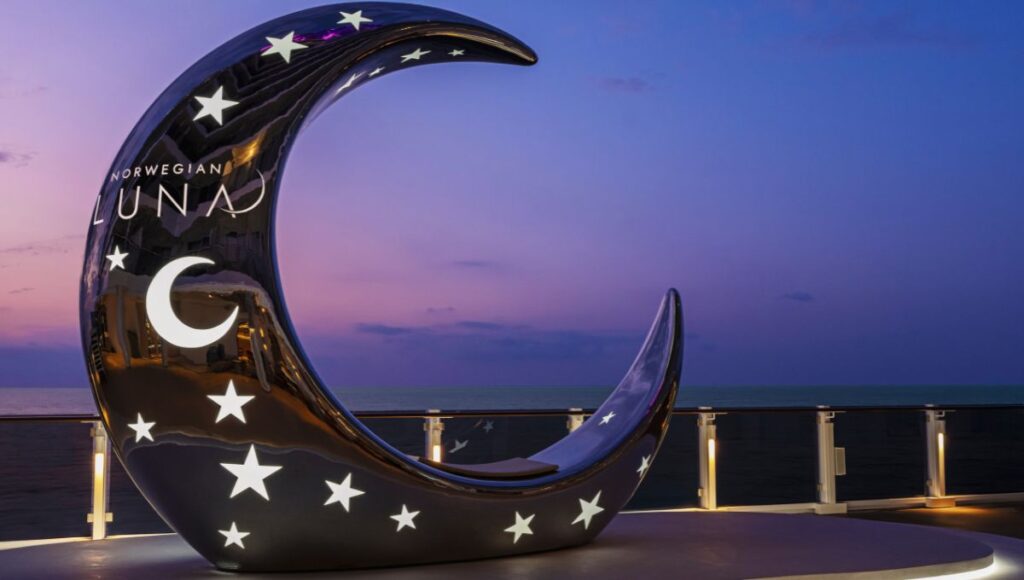 Norwegian Luna Moon photo spot with illuminated crescent sculpture overlooking the ocean