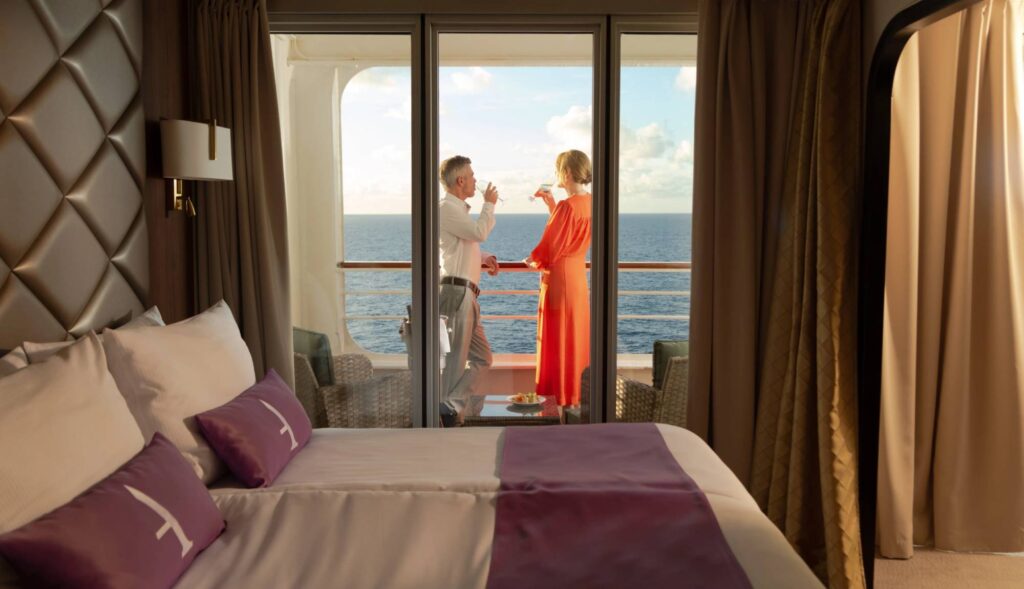 Paramount Cruises guests enjoying drinks on their balcony on an Ambassador Cruise Line holiday.