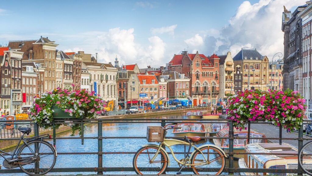 Traditional canal houses and bicycles overlooking a canal in Amsterdam, Netherlands.