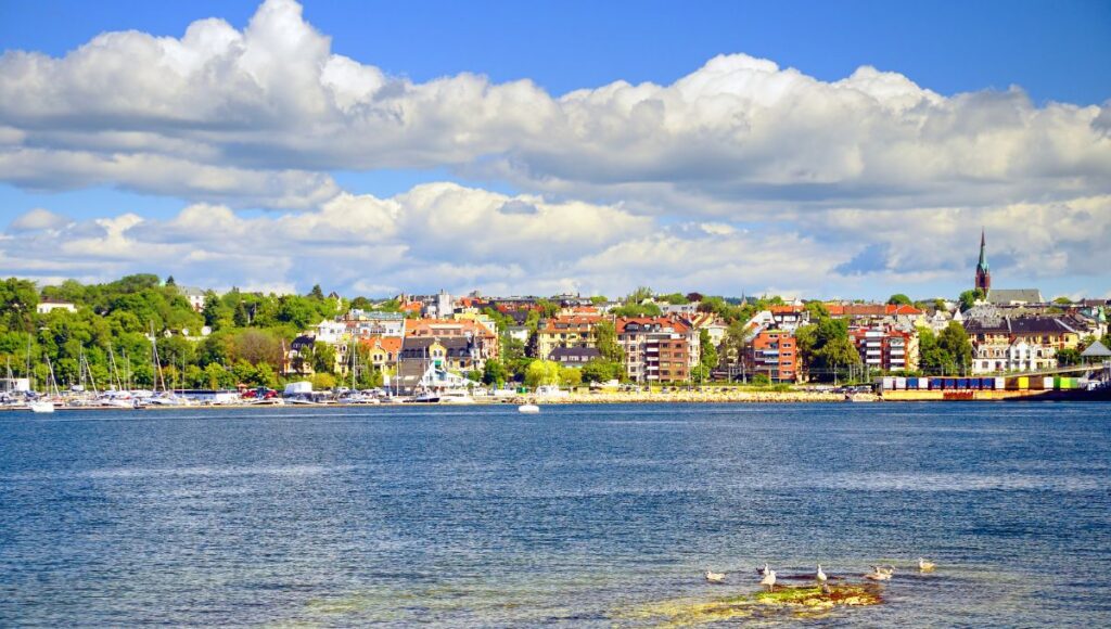 Waterfront skyline of Oslo, Norway, viewed across the Oslofjord on a sunny day.