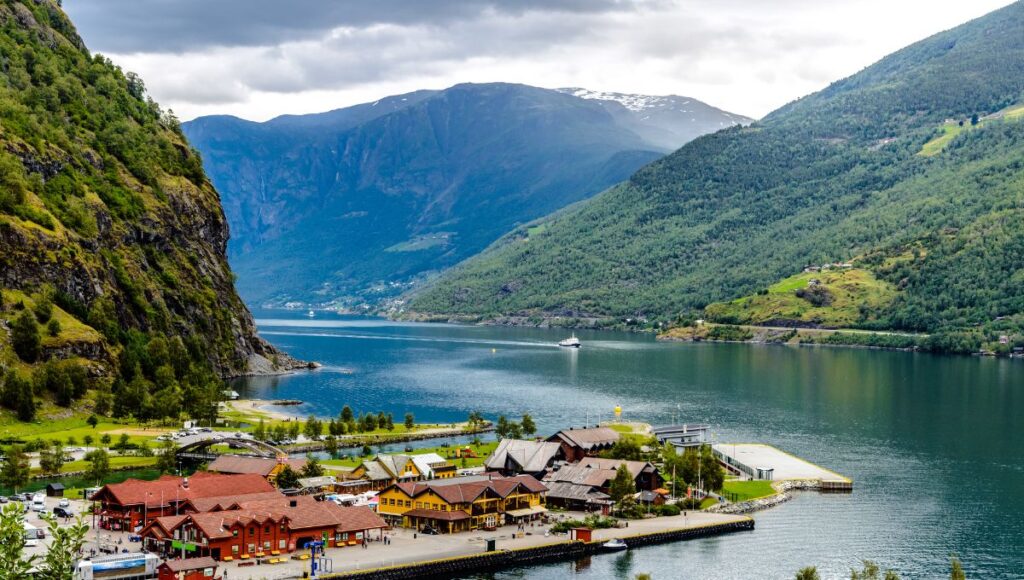 Scenic view of Flåm, Norway, surrounded by dramatic fjords and towering mountains.