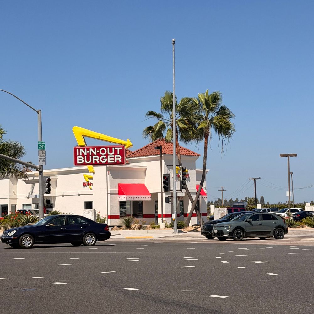 Exterior of In n Out burger & palm trees in Long Beach, California.