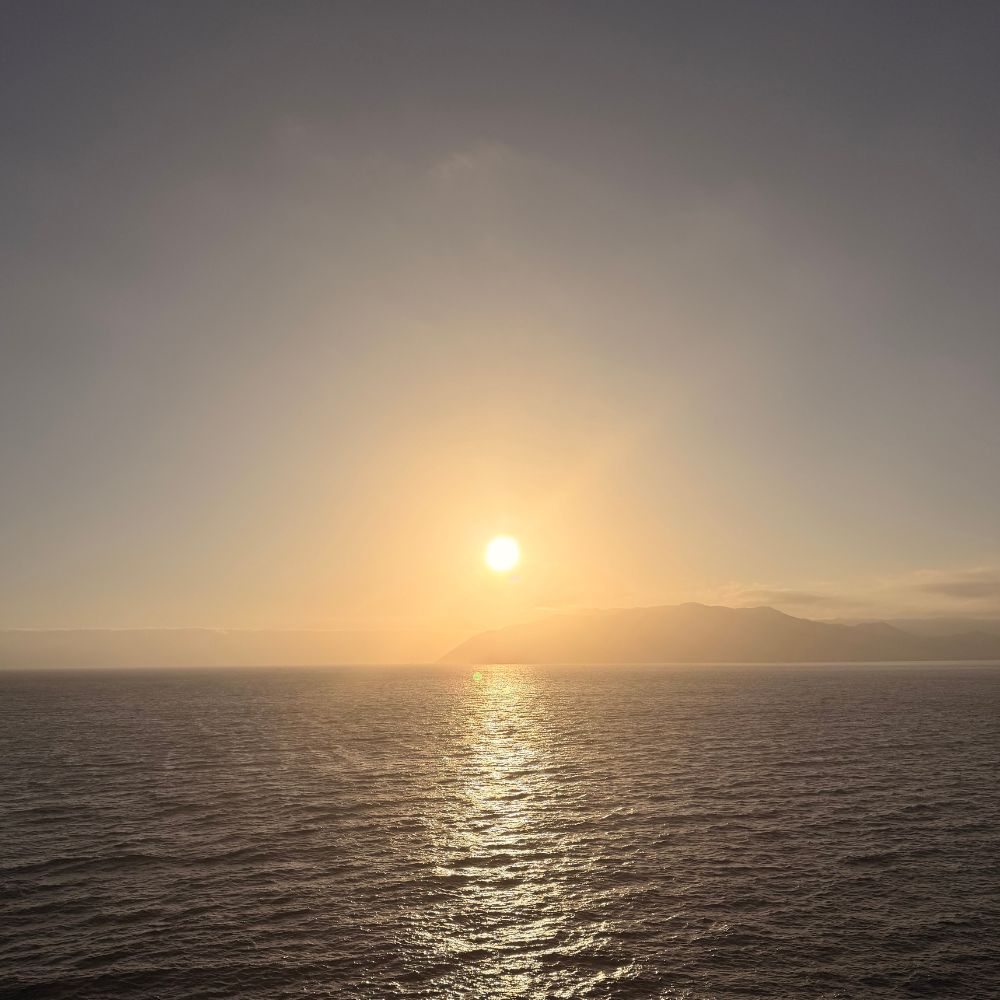View of the sunset at sea from a balcony cabin
