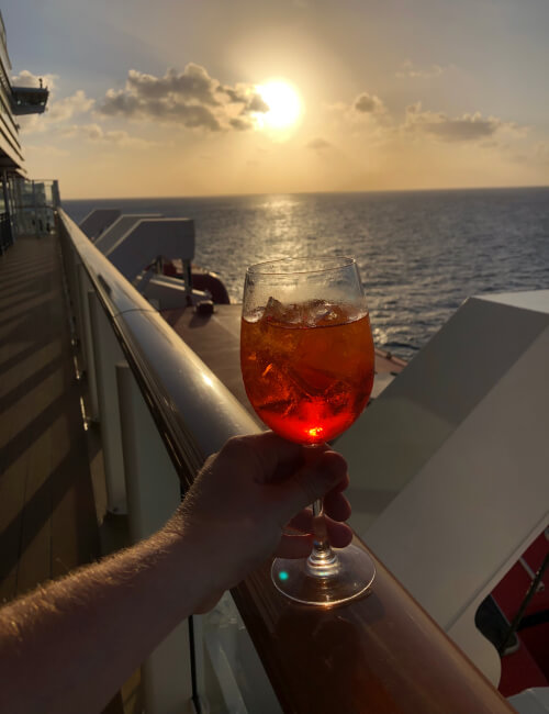 An aperol spritz onboard an NCL ship whilst the sun sets.