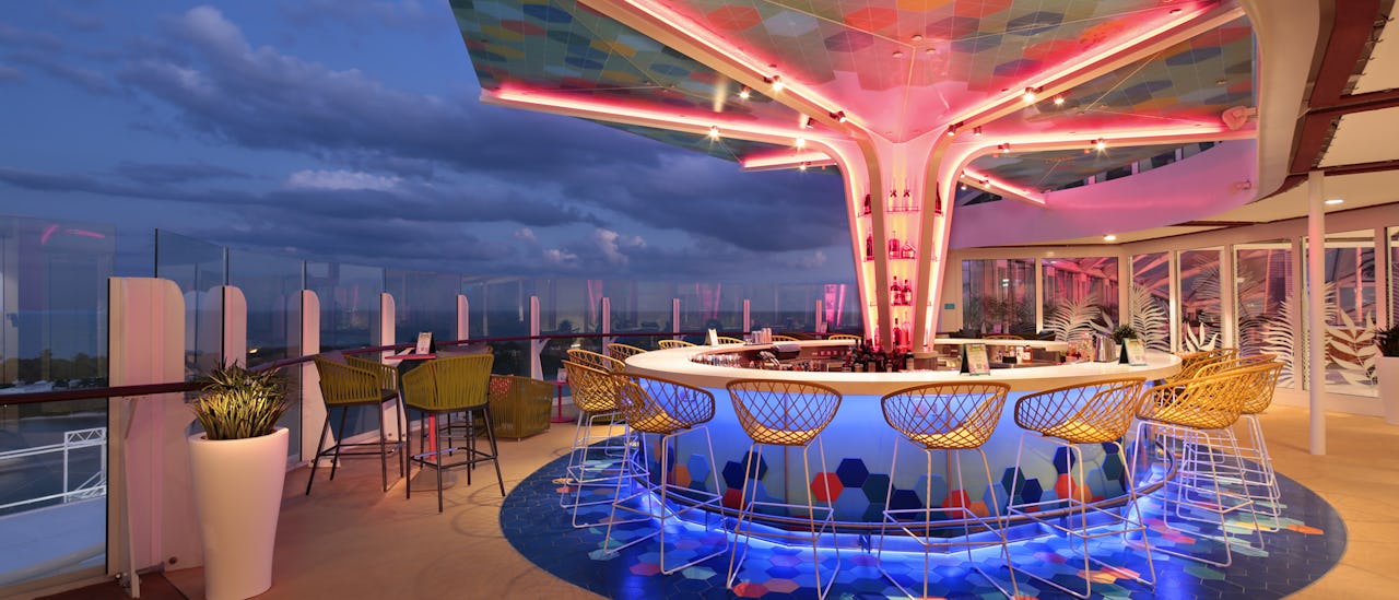 Enjoy a cocktail in The Vue Bar - the bar has a colorful mosaic canopy overhead after sunset