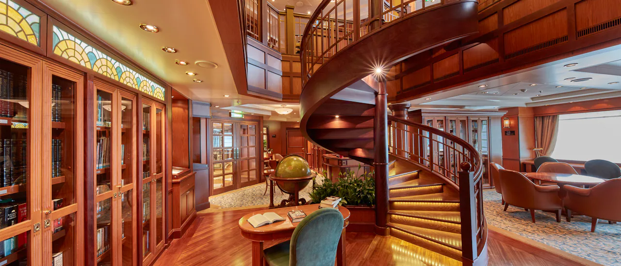 Borrow a book from the library, where over 8,000 books and magazines in the largest library at sea are at your fingertips