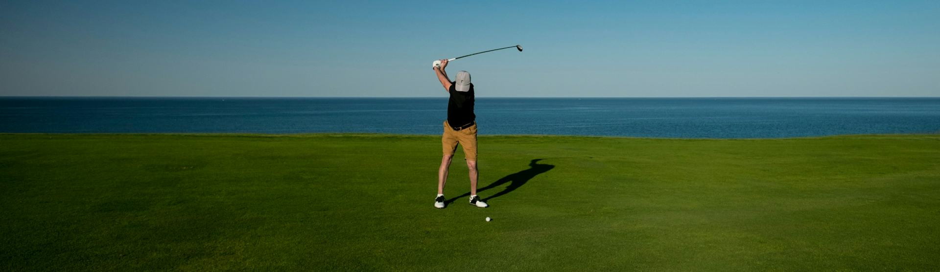 Golf Cruises - man playing gold by the sea