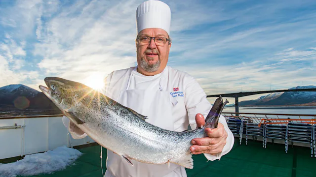 Hurtigruten Dining - Chef with a fish on deck