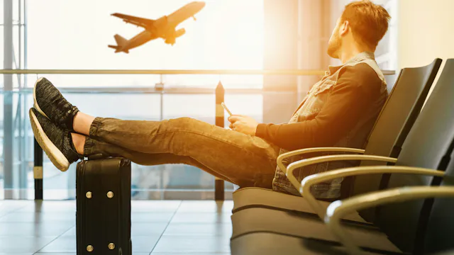 Man waiting for a flight at an airport