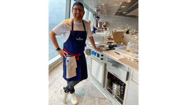 Marco experiences the Chef’s Kitchen aboard Explora Journeys, preparing dishes alongside the onboard culinary team in its intimate ocean-front cooking school.