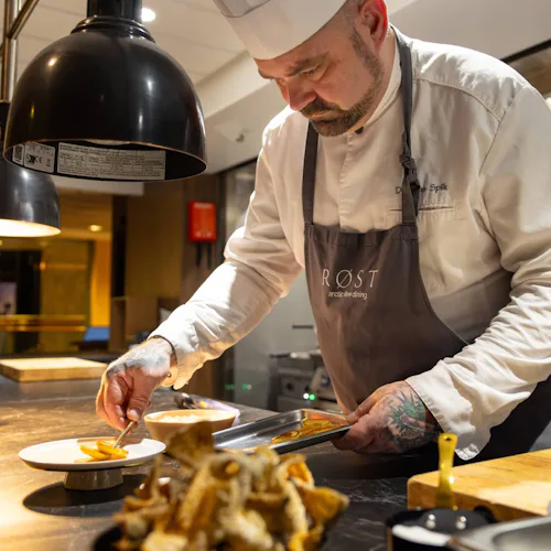 Hurtigruten Dining - Chef at Røst prepering food