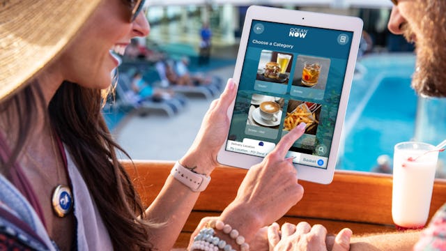 Guests using an IPad to order food with Ocean Medallion