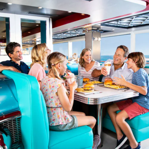 Family enjoying food at the American Diner onboard NCL Encore