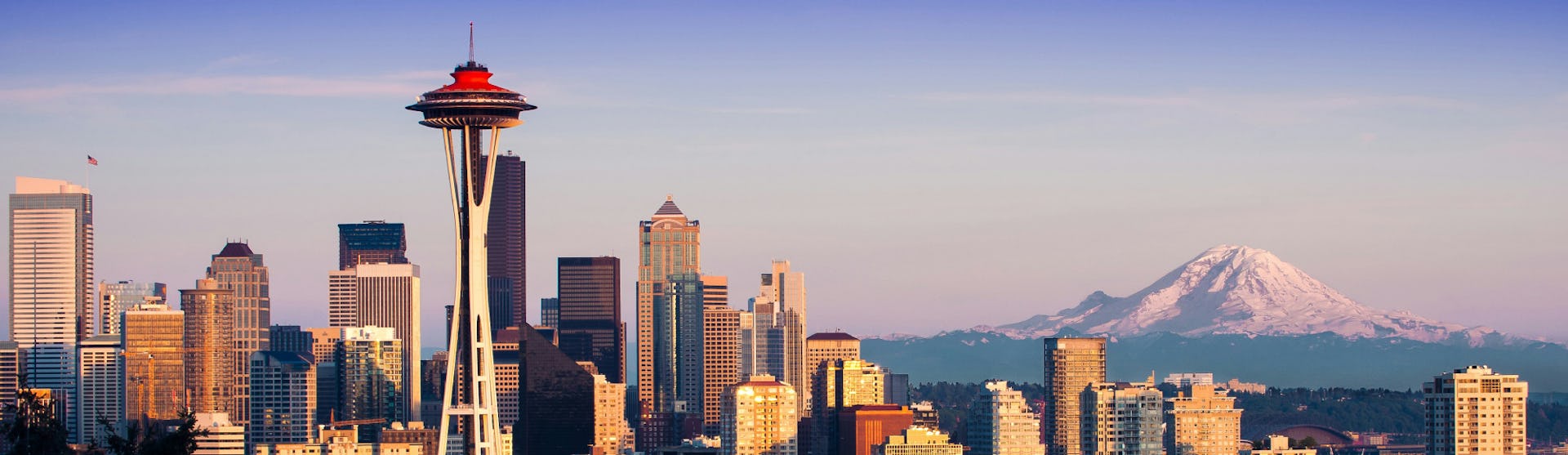 Seattle's famous skyline with Space Needle in the foreground and mountains in the background