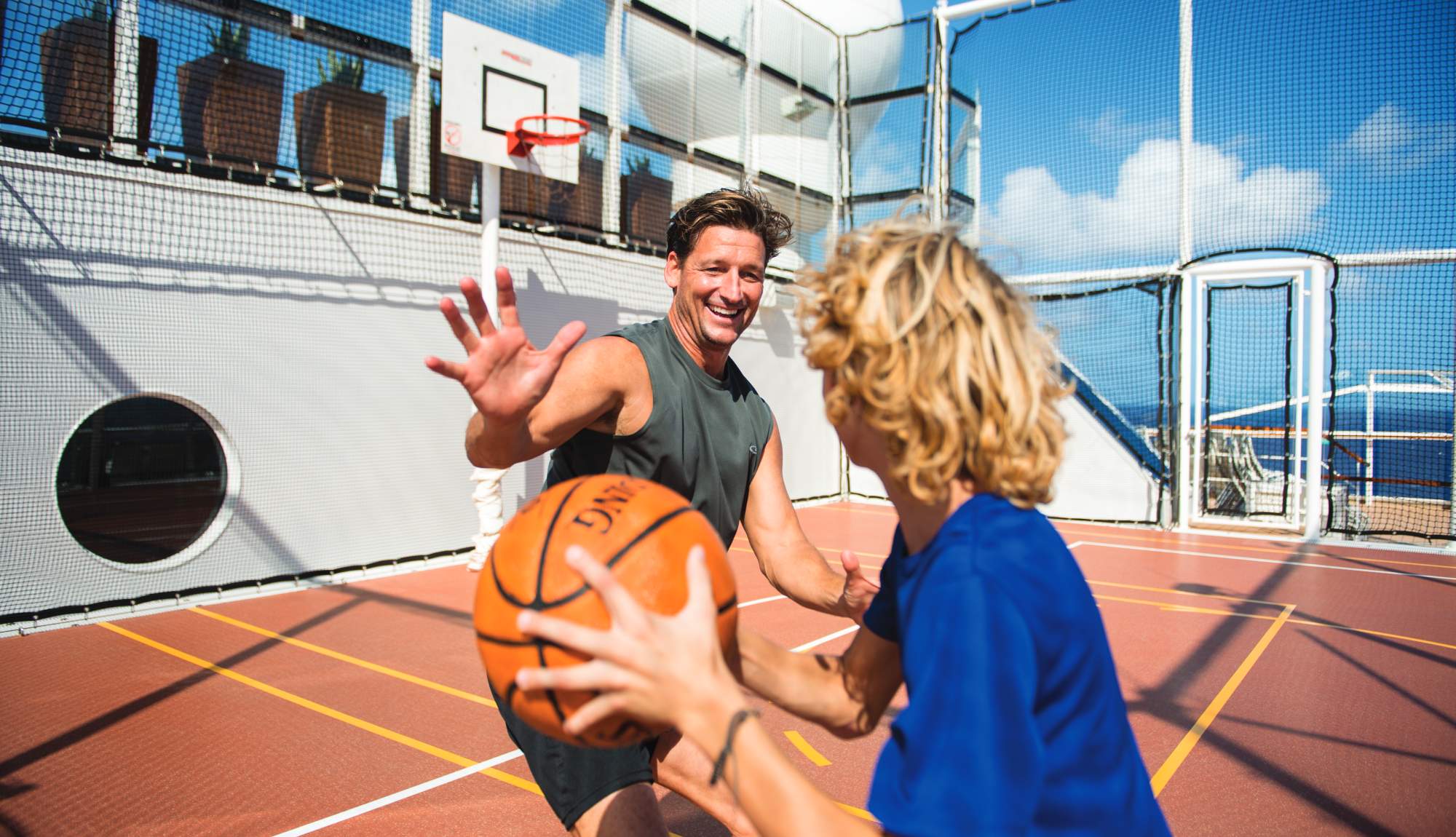 Family playing basketball onboard Celebrity Cruises