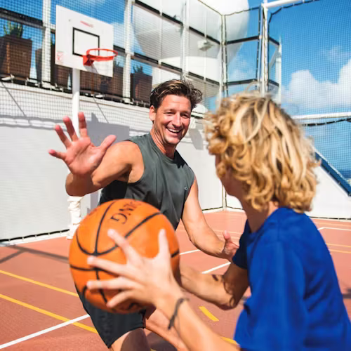 Family playing basketball onboard Celebrity Cruises