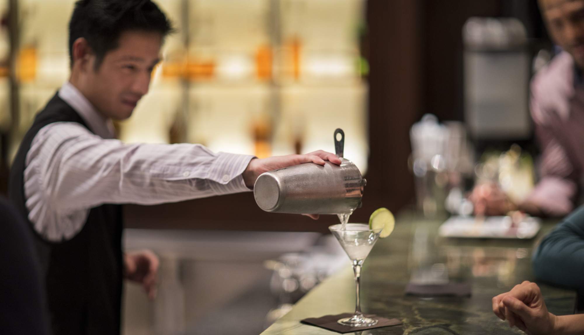 Celebrity Cruises barman serving a martini