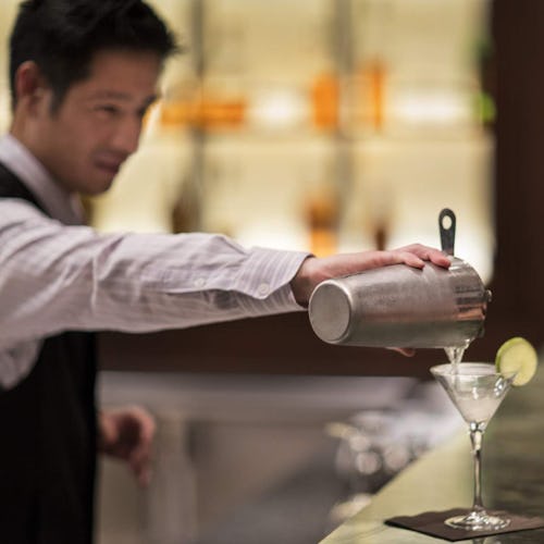 Celebrity Cruises barman serving a martini