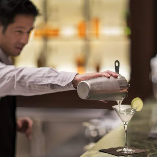 Celebrity Cruises barman serving a martini