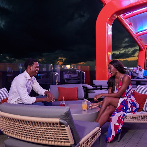 Couple enjoying drinks on the magic carpet