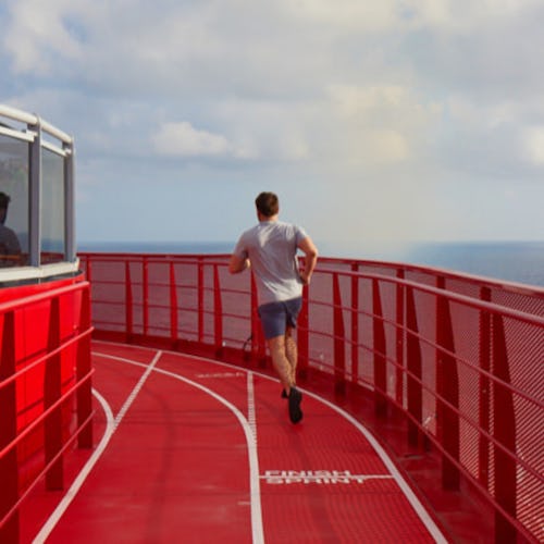 Man running on the running track onboard Virgin Voyages