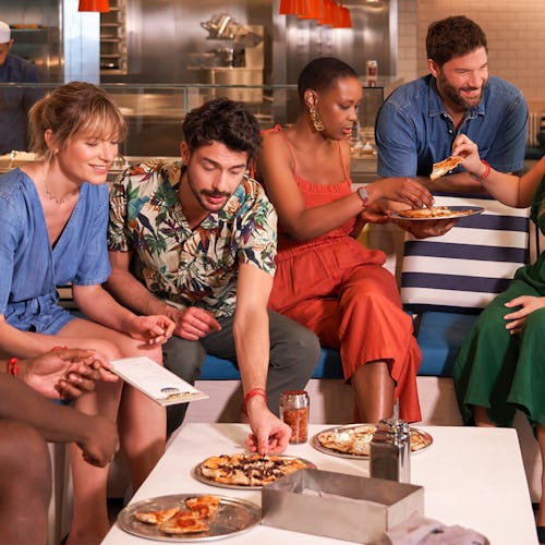 Friends enjoying pizza at The Pizza Place onboard Virgin Voyages