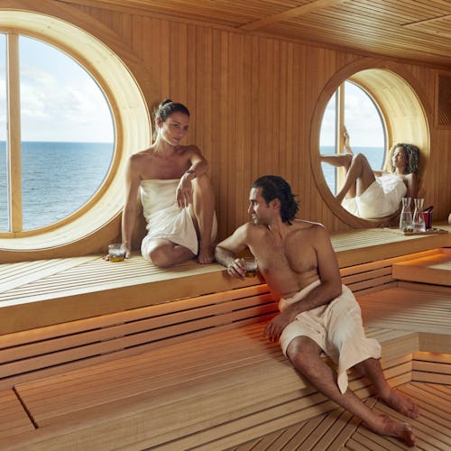 Group of people relaxing in the sauna at the Redemption Spa onboard Virgin Voyages
