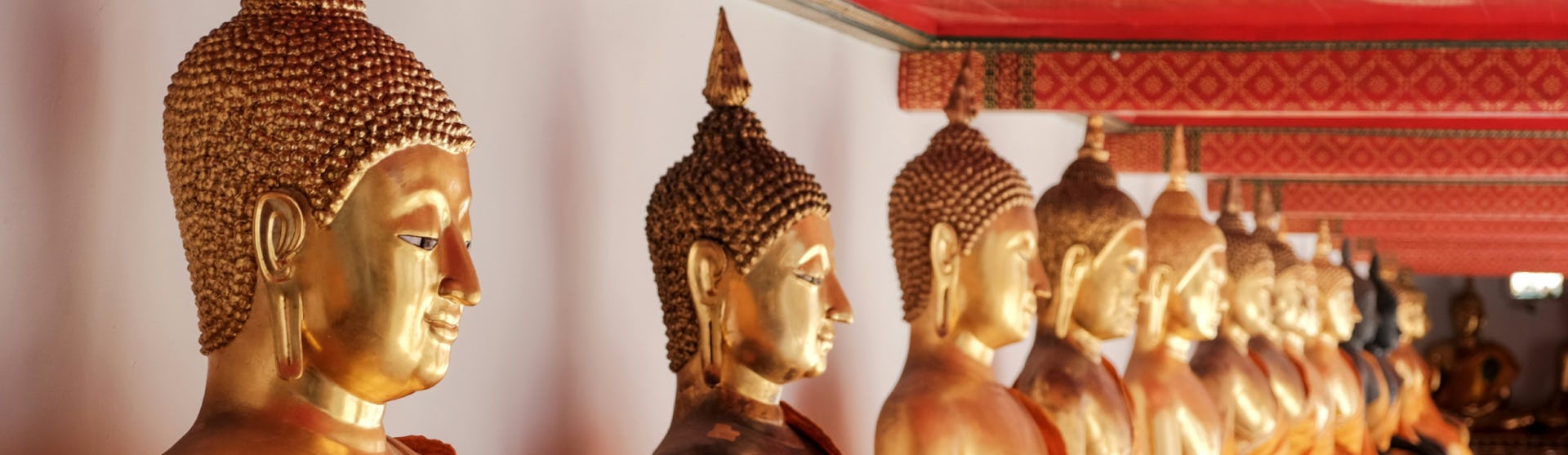 Gold buddha statues at Wat Pho temple in Bangkok, Thailand