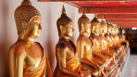 Gold buddha statues at Wat Pho temple in Bangkok, Thailand