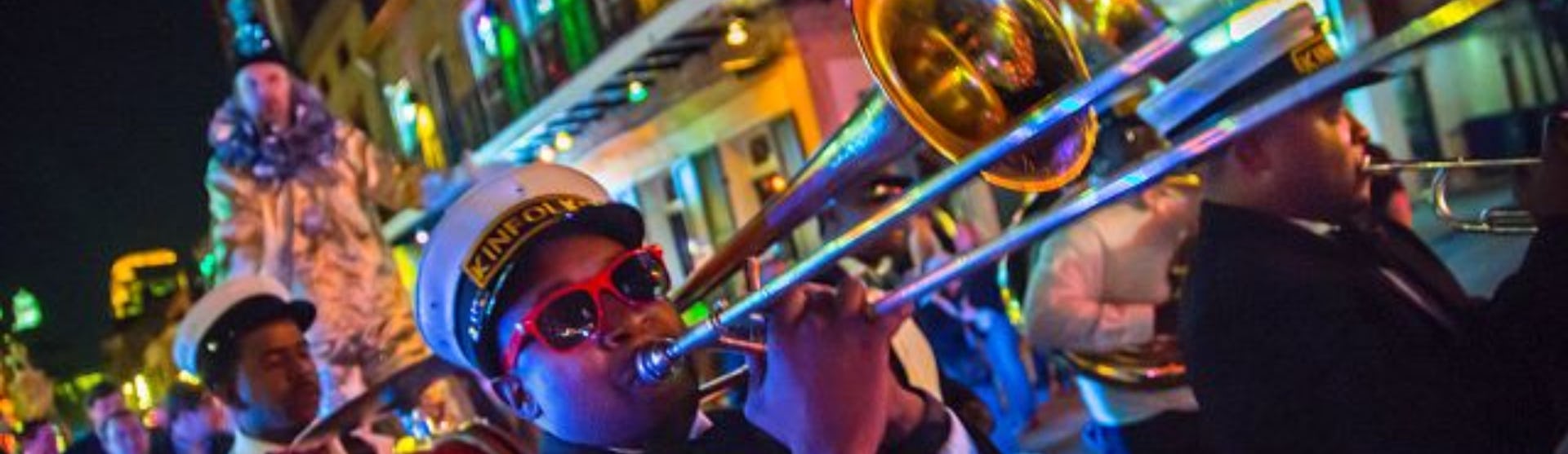 Brass band rolling through New Orleans during Mardi Gras