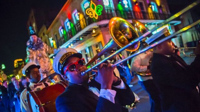 Brass band rolling through New Orleans during Mardi Gras