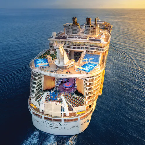 Allure of the Seas sailing into the sunset