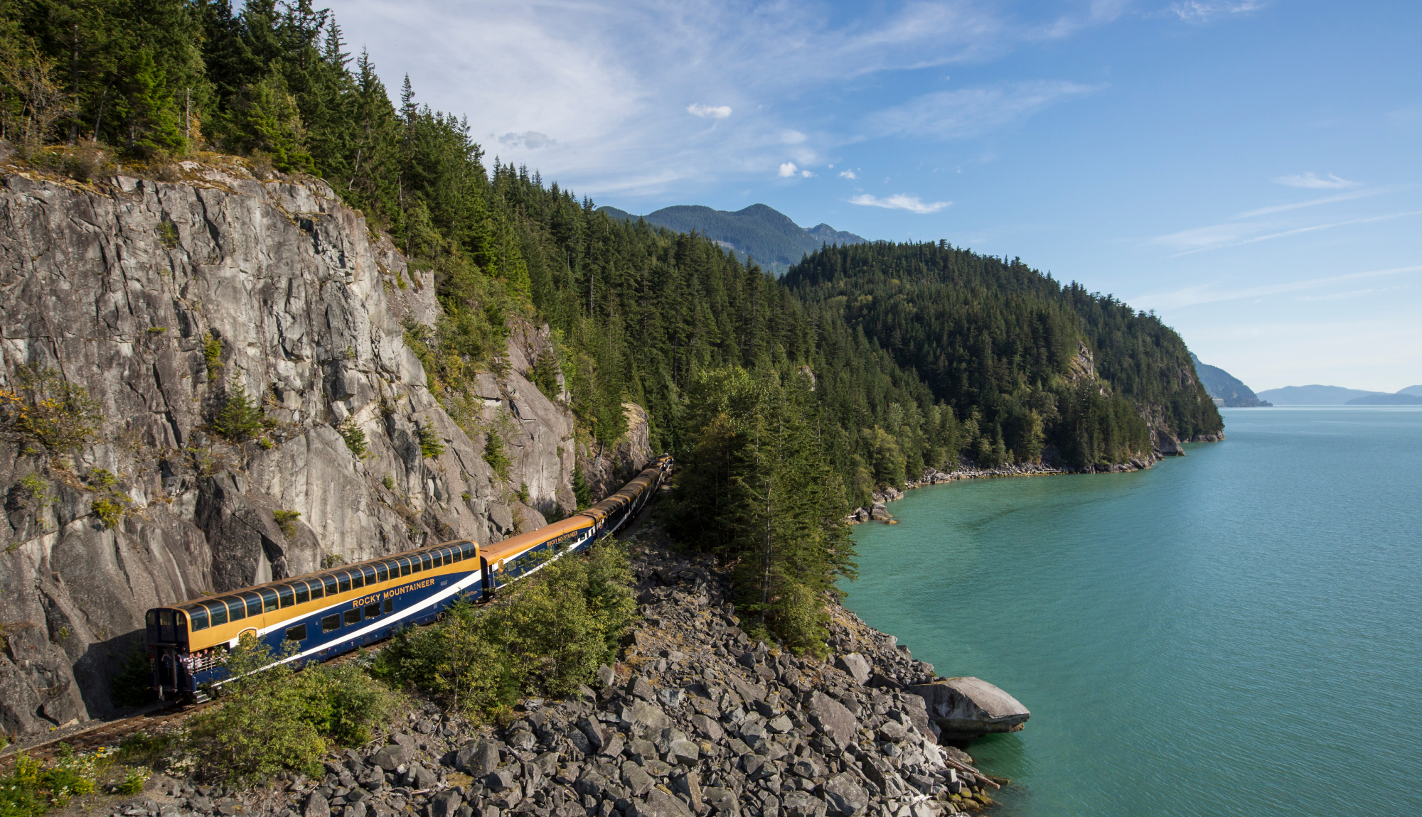 Exterior of Rocky Mountaineer train near Sea-to-Sky Highway along Rainforest to Goldrush route.