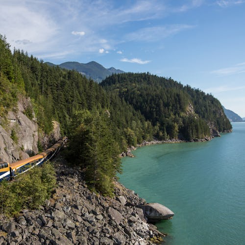 Exterior of Rocky Mountaineer train near Sea-to-Sky Highway along Rainforest to Goldrush route.