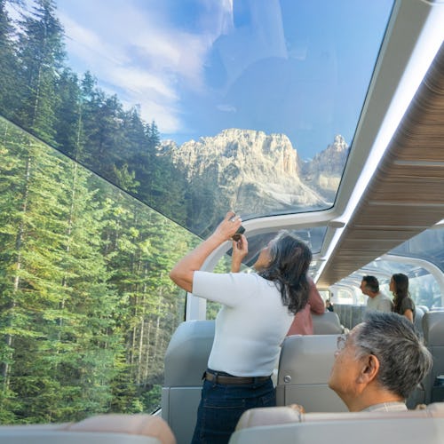 Guests in a GoldLeaf carriage onboard Rocky Mountaineer enjoying the scenery.