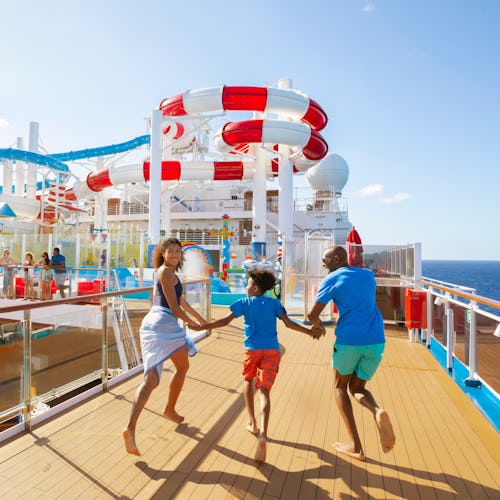 Family running towards waterslides onboard a Carnival ship