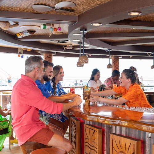 People enjoying a drink at Red Frog Rum Bar onboard a Carnival ship